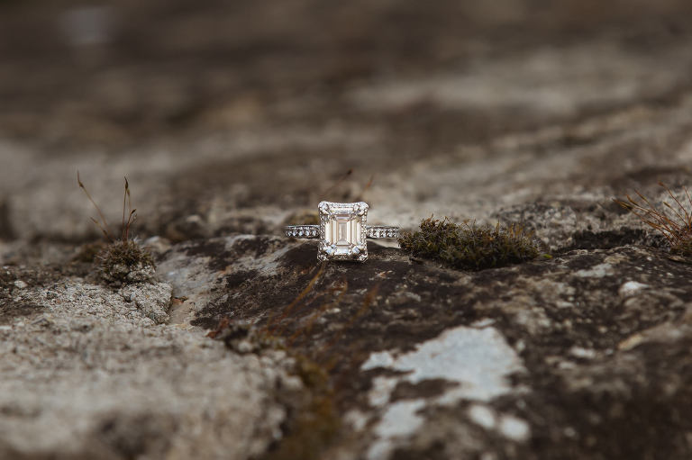 engagement ring on mossy wall at destination wedding venue