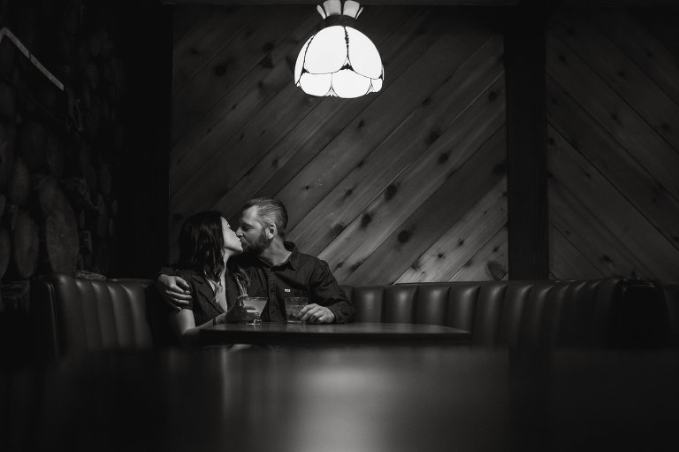 couple kissing in booth at dive bar captain keno's encinitas engagement session