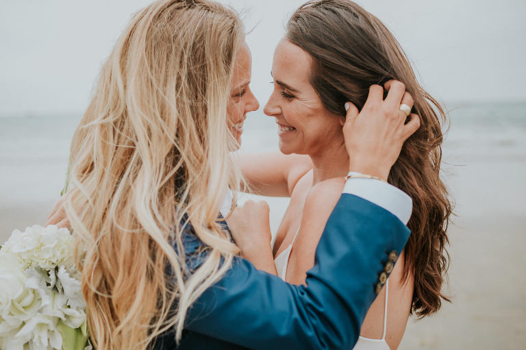 two brides embracing