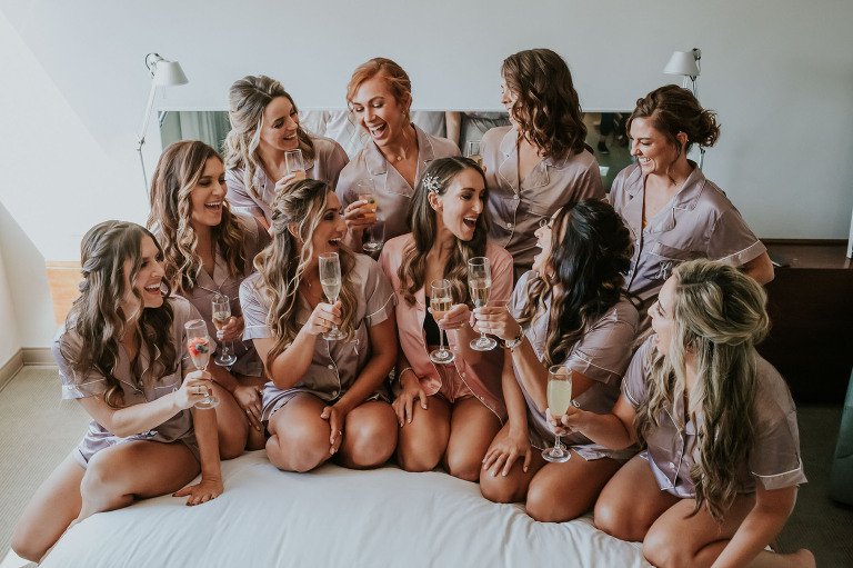 bridesmaids in matching pjs with champagne