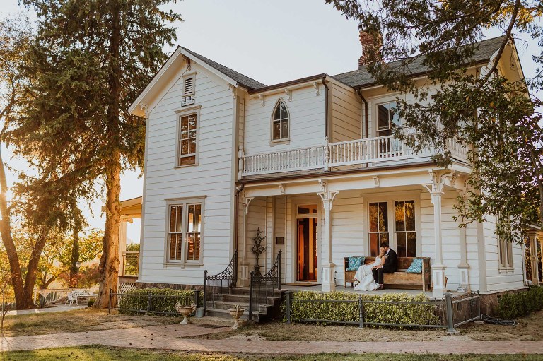 Napa Valley Victorian house with bride and groom at sunset