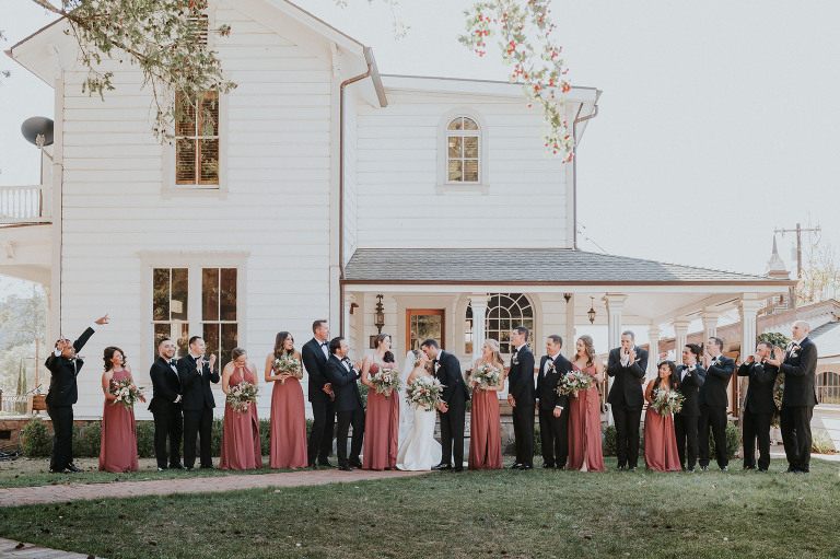 wedding party in front of Victorian house at Triple S Ranch