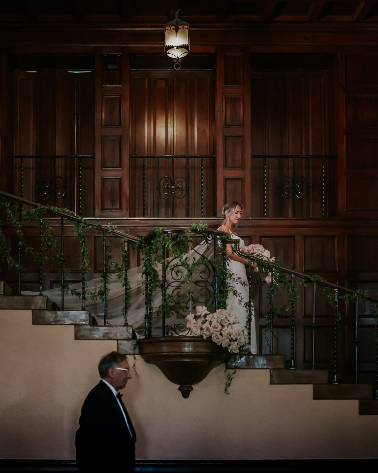 bride walking down grand staircase at the ebell