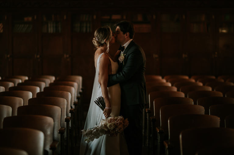 bride and groom kissing in theater at the ebell of los angeles