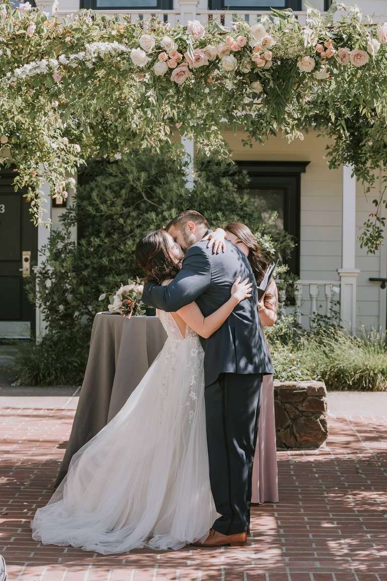 first kiss of bride and groom in Sonoma wedding ceremony