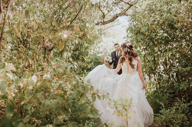 bride and groom walking through garden in sonoma