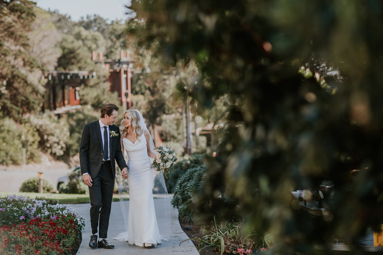 bride and groom walk along path at Martin Johnson House UCSD